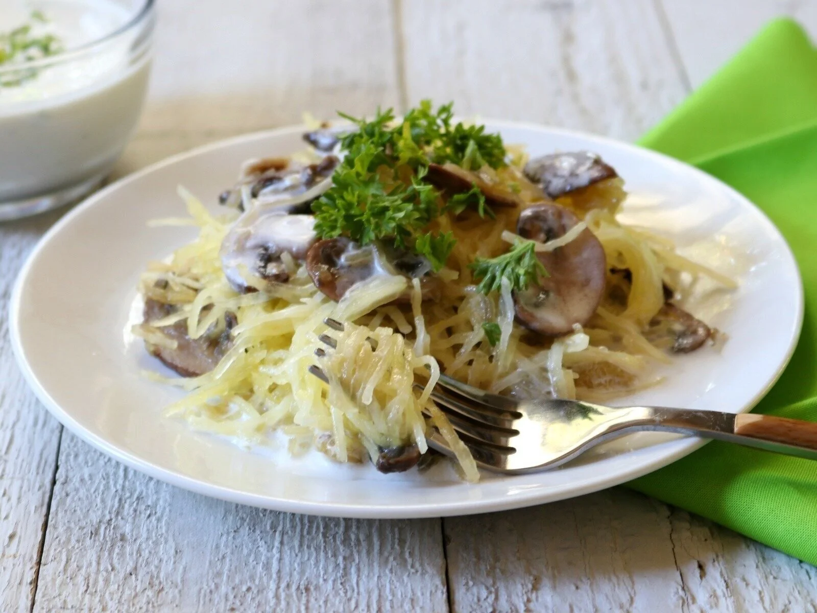 Pretty Caucasian woman at the beach smiling at camera.