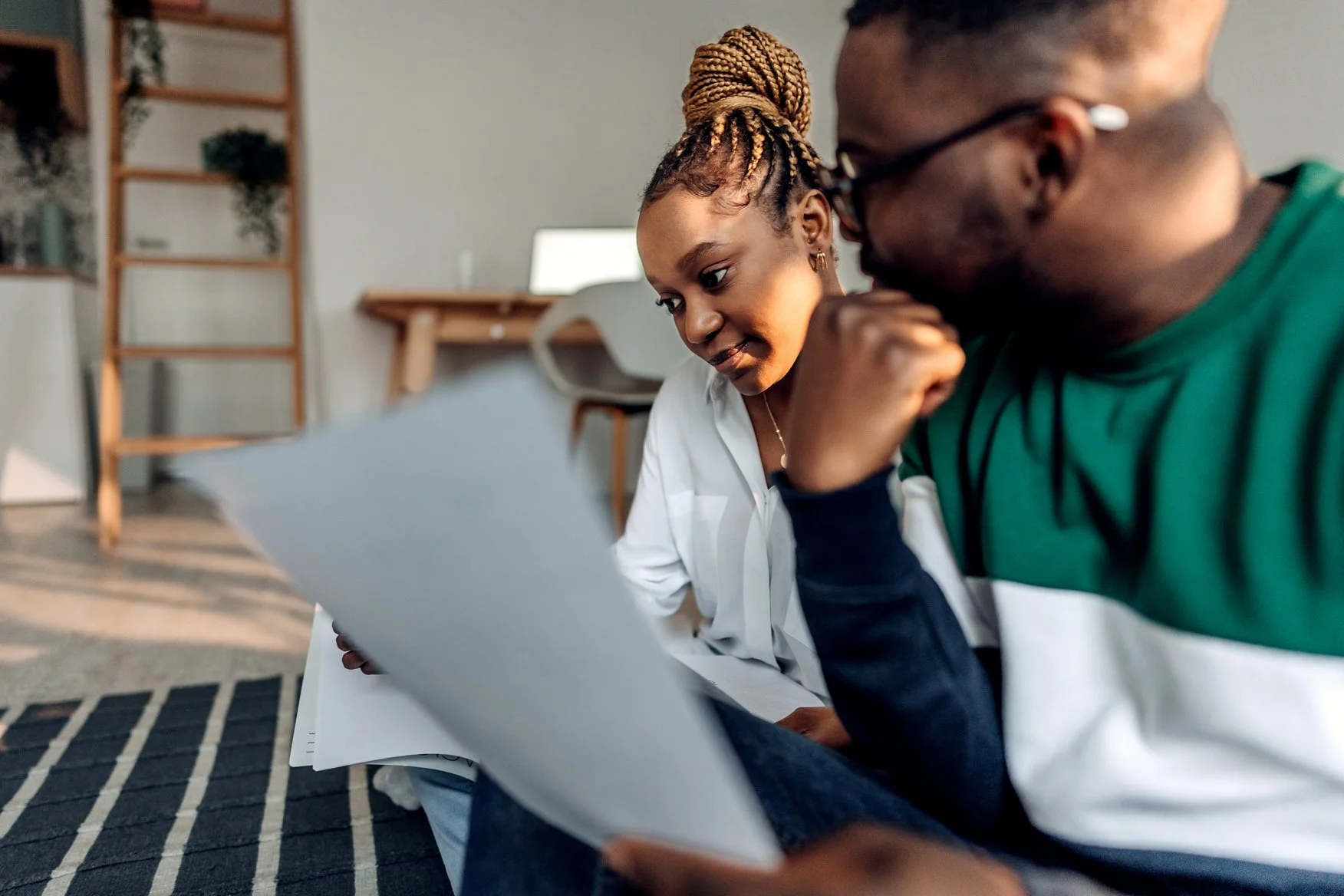 A young couple reviewing a house hold bill