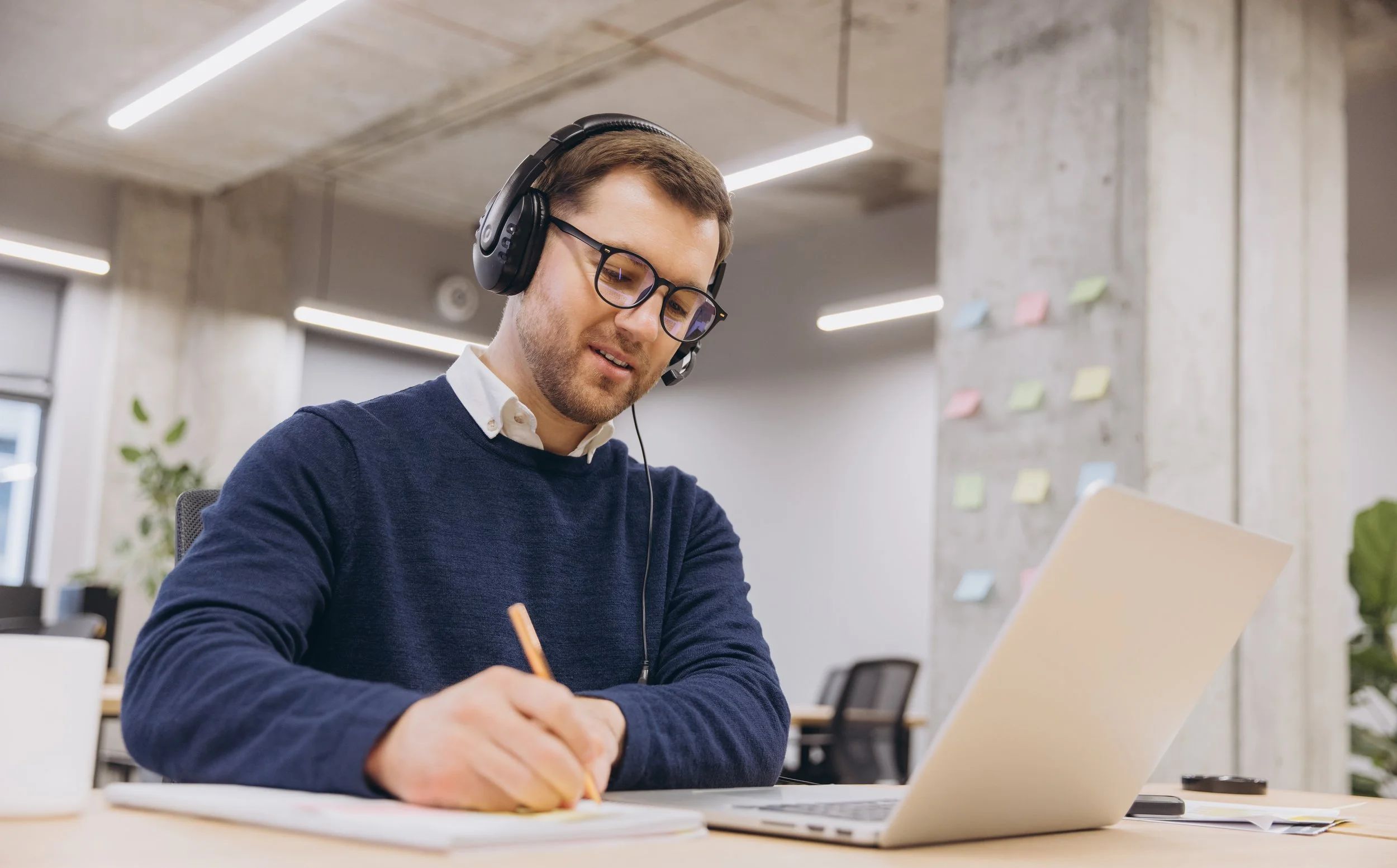 A young professional writing at a desk