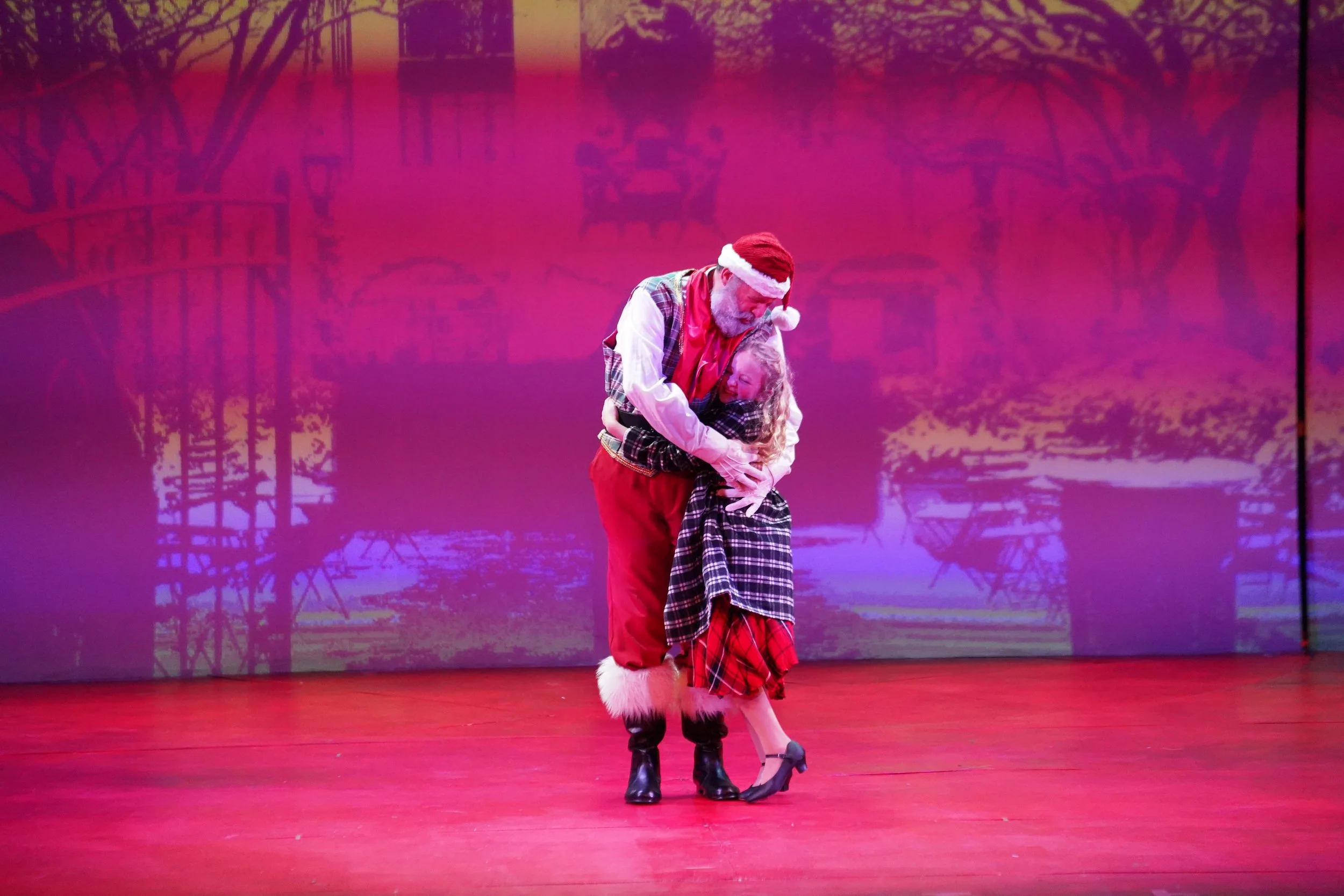  Santa offers a young girl a hug.  