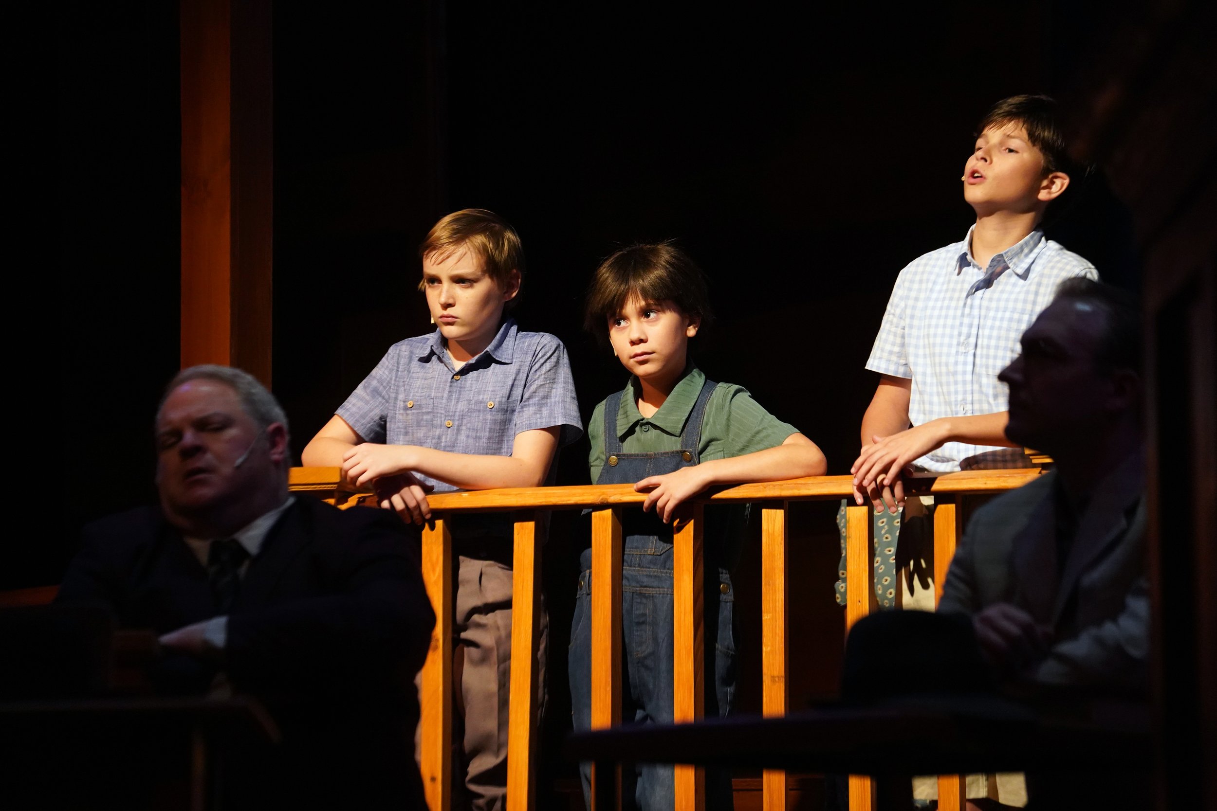 Children watch court while rest is in shadow