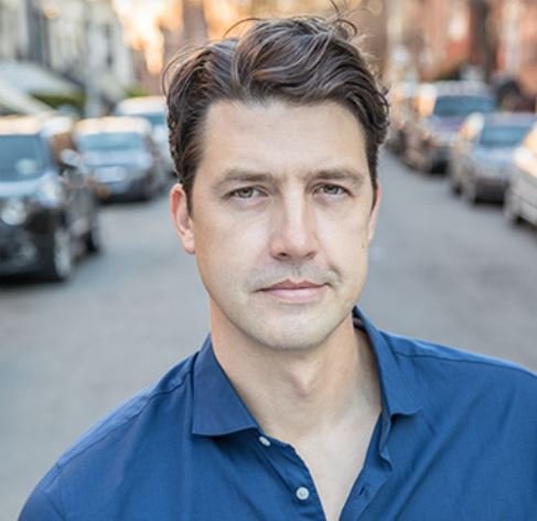 Actor in blue shirt