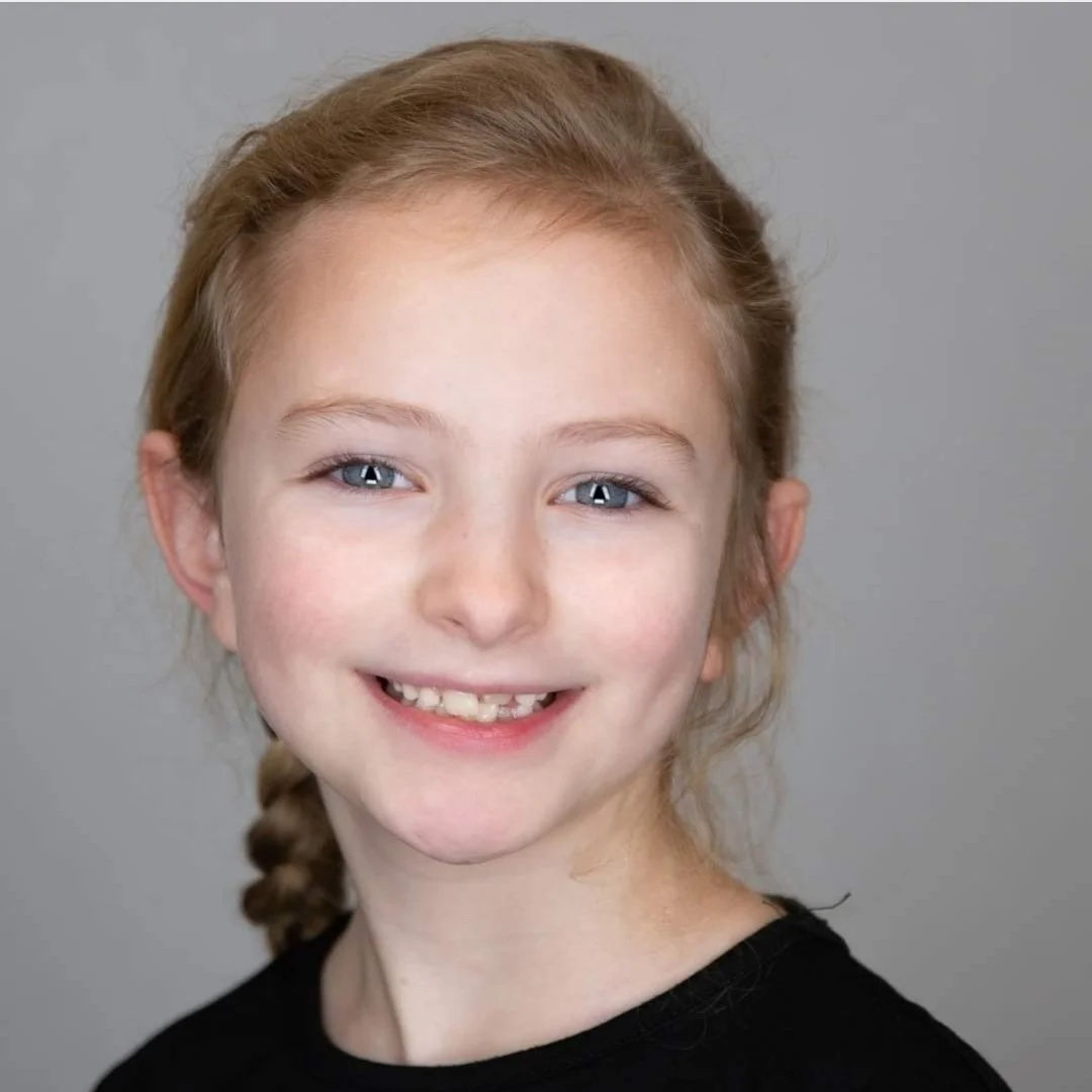 Child with braid smiling
