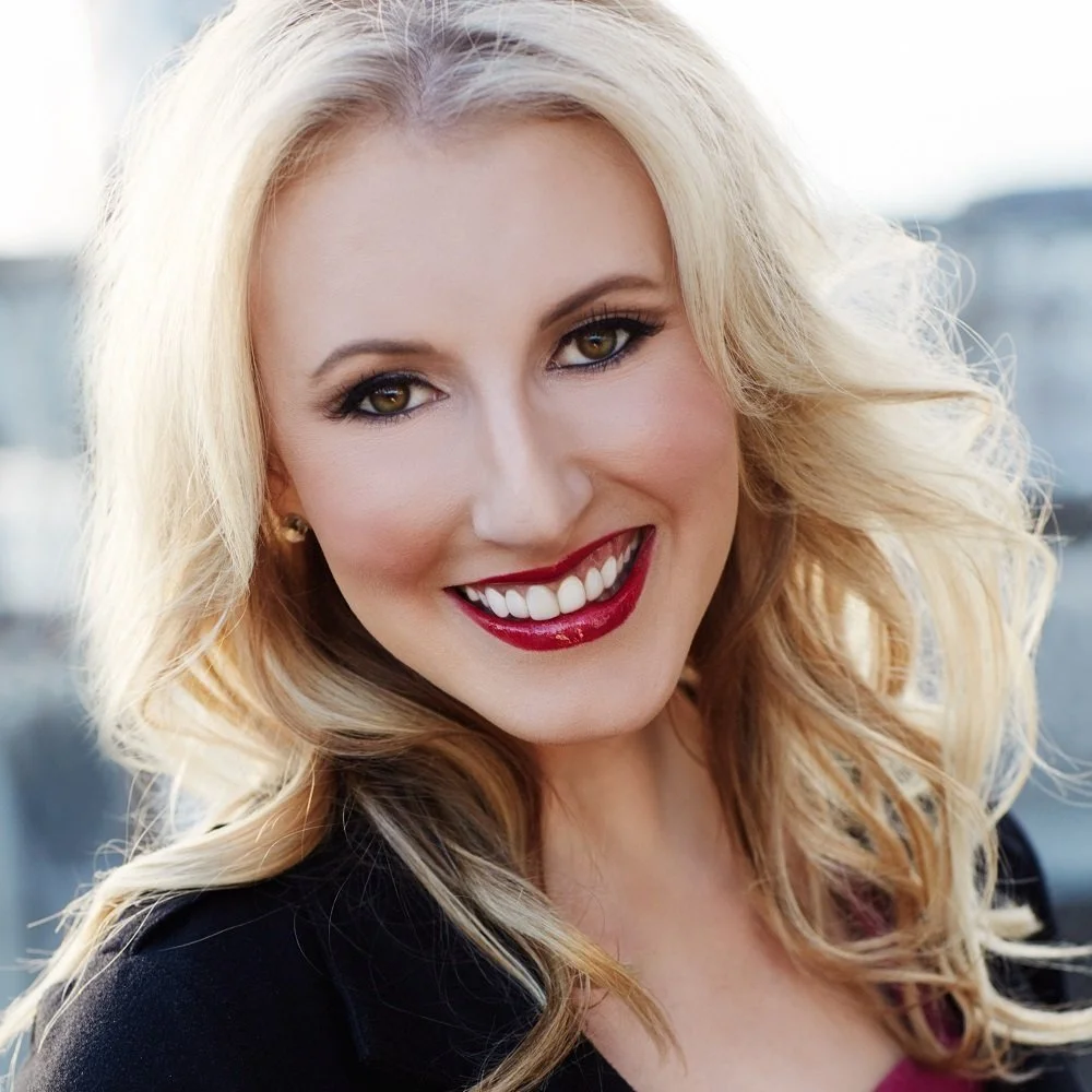 Woman with blonde hair smiles at camera