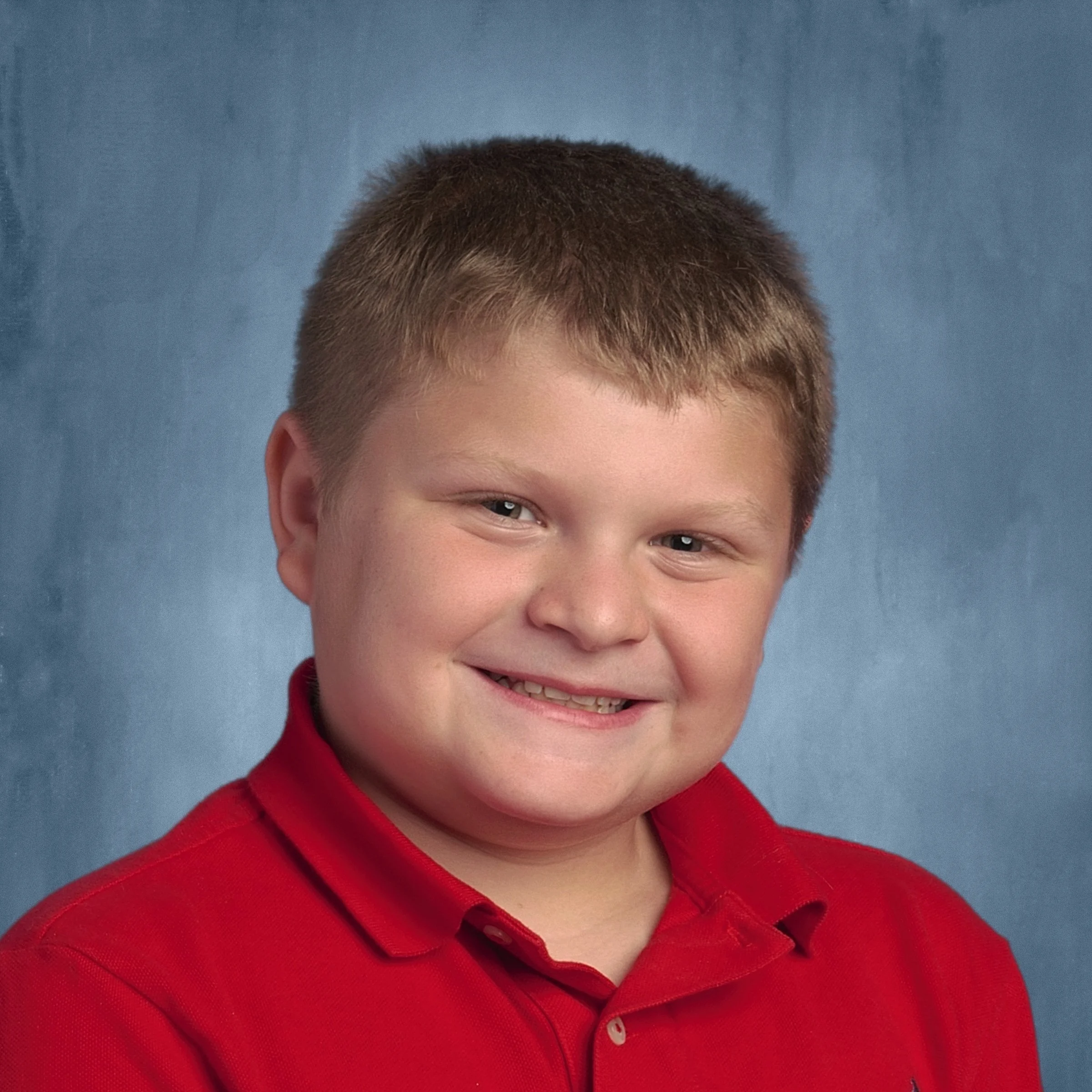Child with short hair smiles for picture