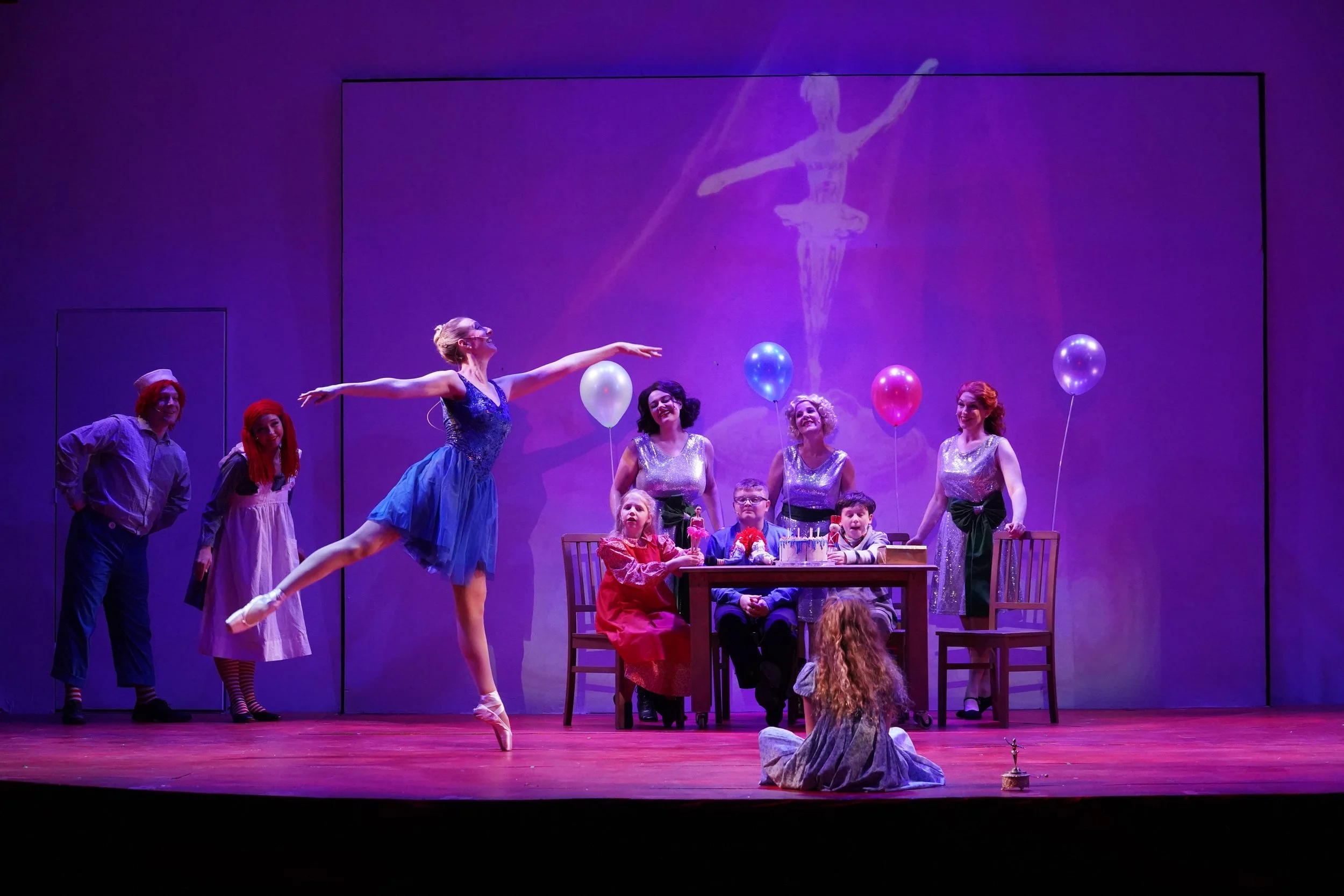   TOP: Chris Zavadowski (Marvin Shellhammer), Elizabeth Butler (Doris Walker), and Jim Lawson (Kris Kringle);     ABOVE: members of the ensemble (dance captain Stephanie Wood in blue dress) in ‘Miracle on 34th Street.’ Photos by Suzzane Rossi.  