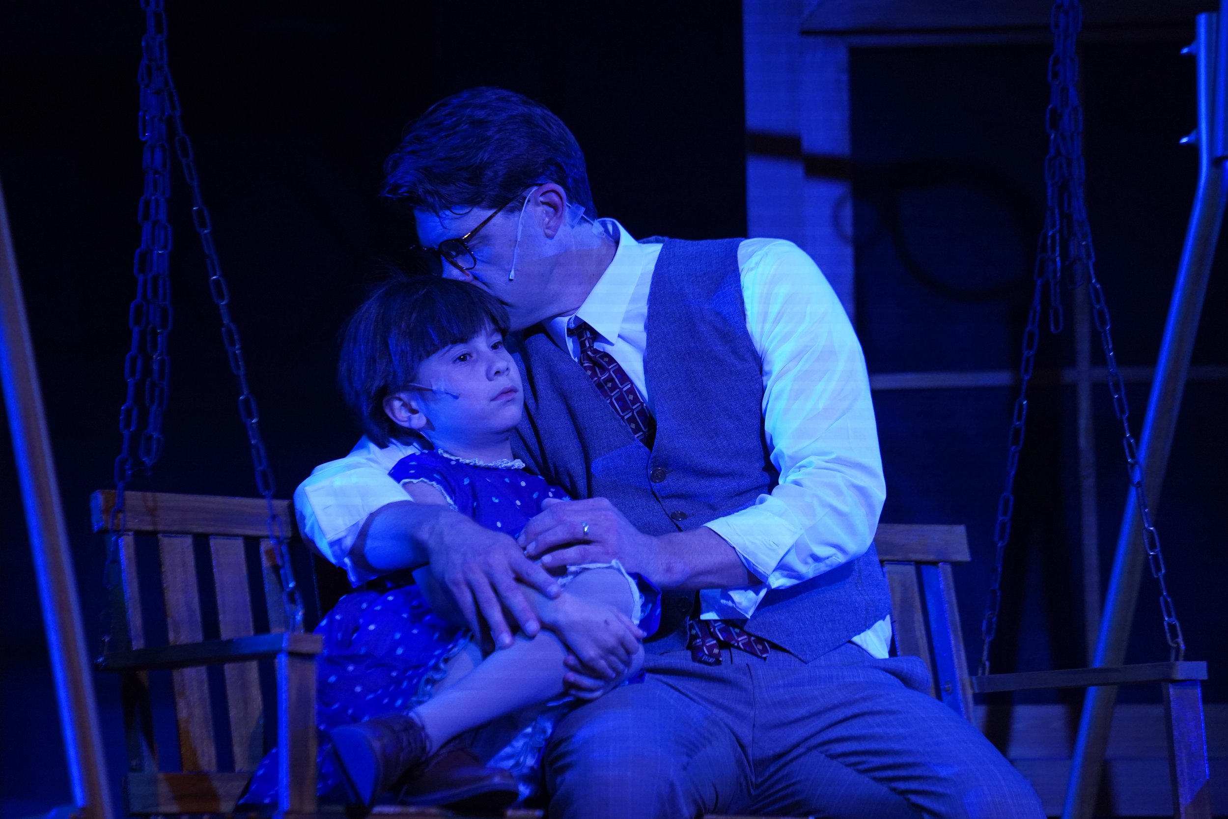 Parent holds child in blue