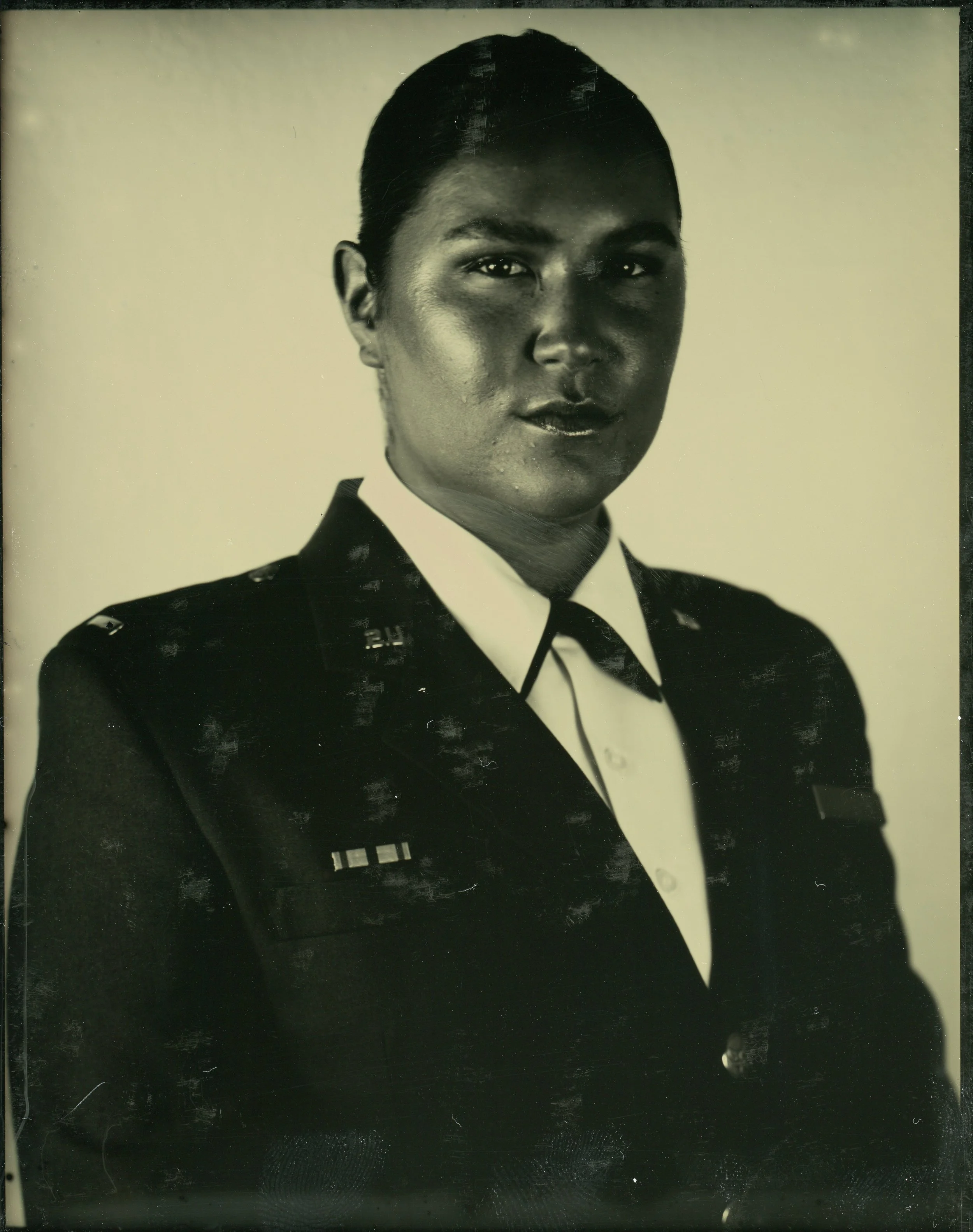 Portrait of a person in military uniform, black and white photograph.