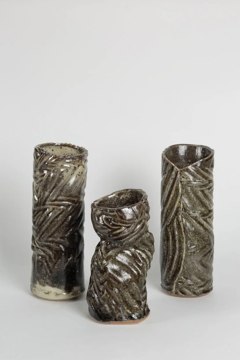 Triptych of three Australian handmade ceramic vessels by Jan Alexander, featuring hand-textured patterns and Shino glaze, reduction fired to produce subtle neutral tones and organic surface variation from trapped carbon.