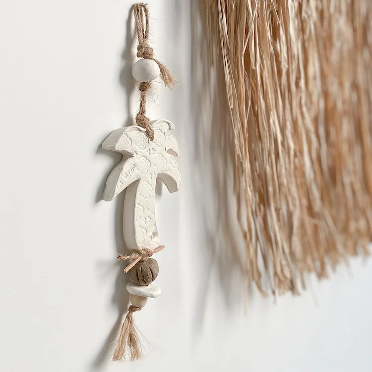 A ceramic palm tree wall hanger with beads