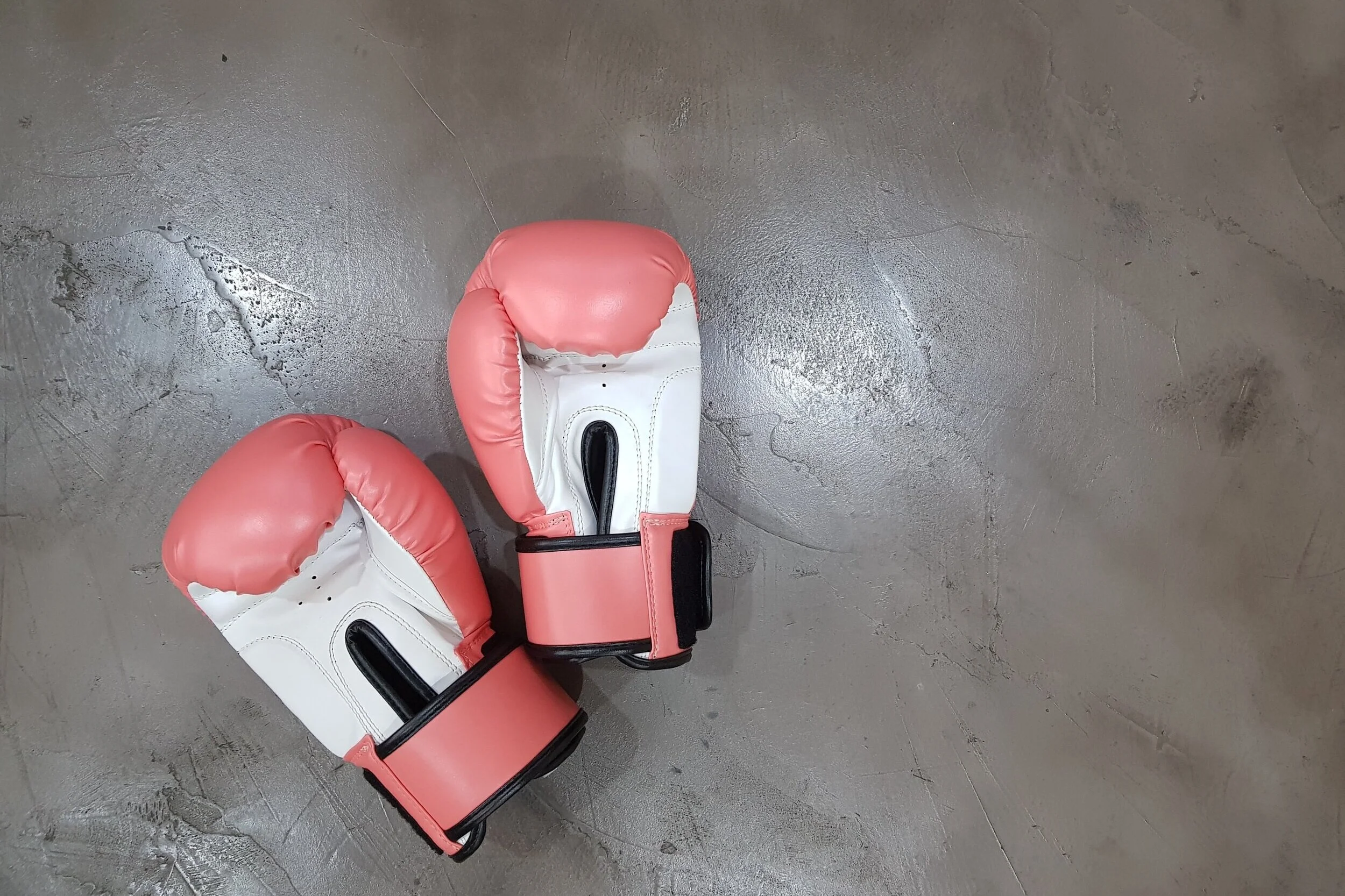 A pair of boxing gloves on the ground