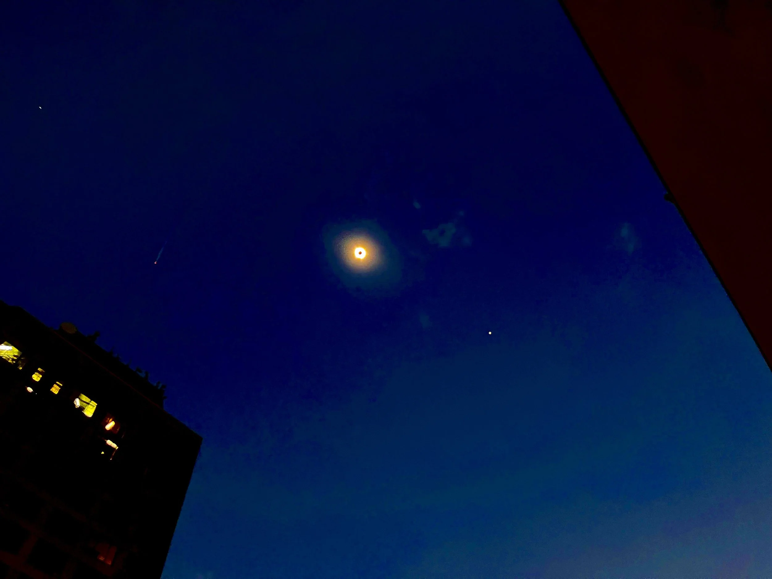 Photograph of a total solar eclipse over Downtown Dallas, Texas, capturing the sky darkened during the rare celestial event.