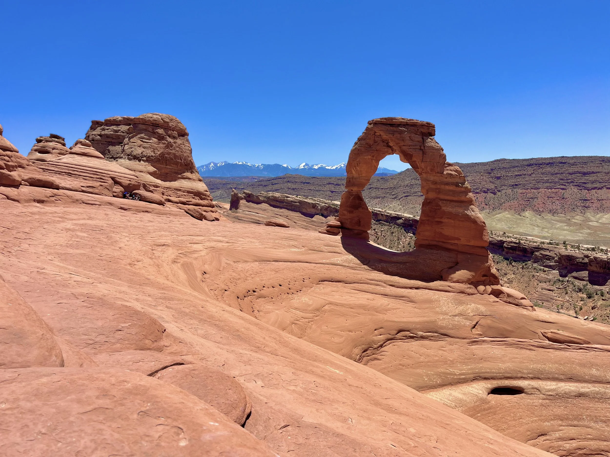 Photograph of Delicate Arch in Arches National Park near Moab, Utah, captured during daylight highlighting sandstone formations.