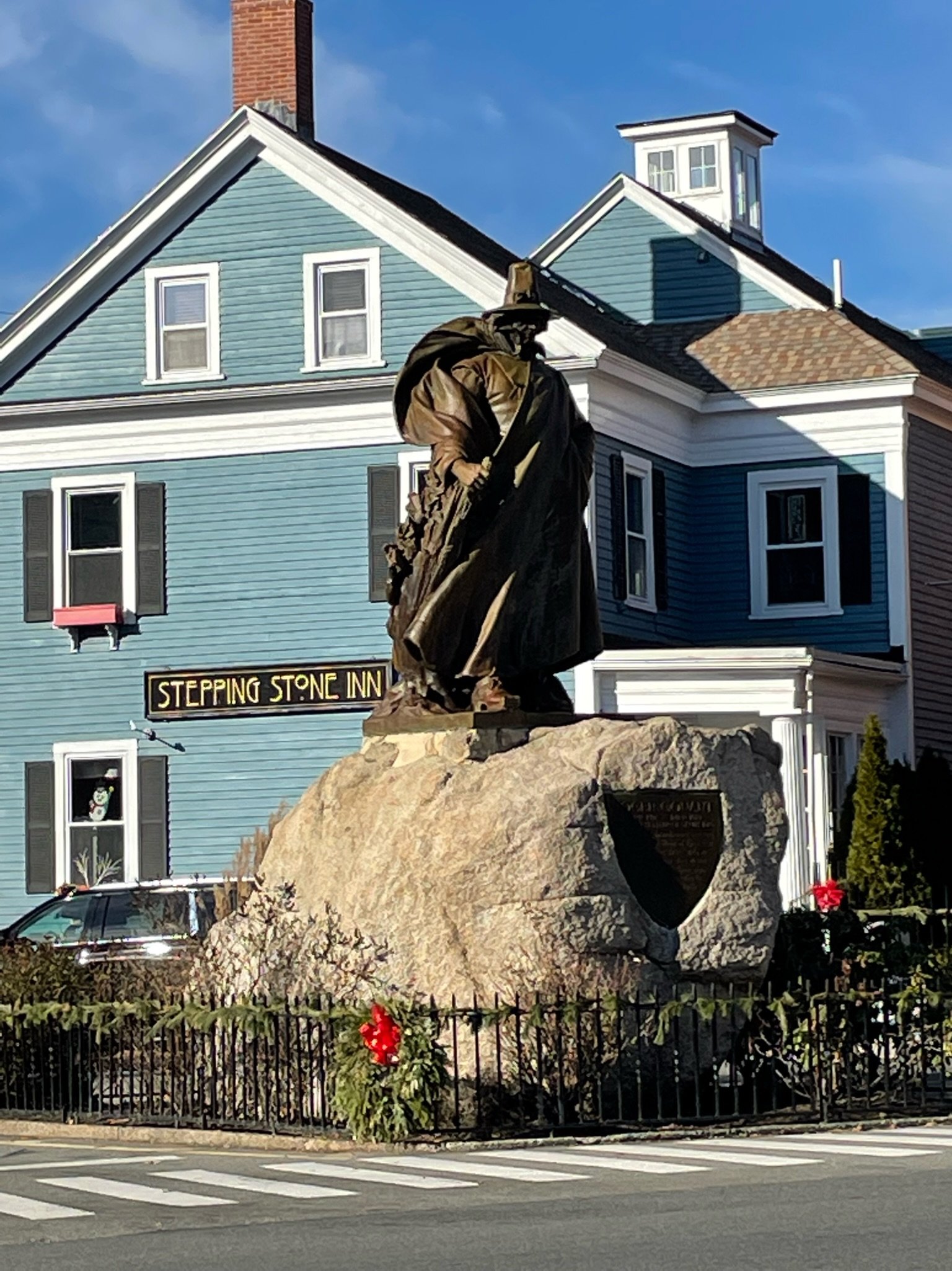 A sculpture of a witch in the middle of the road. It was not a real witch.