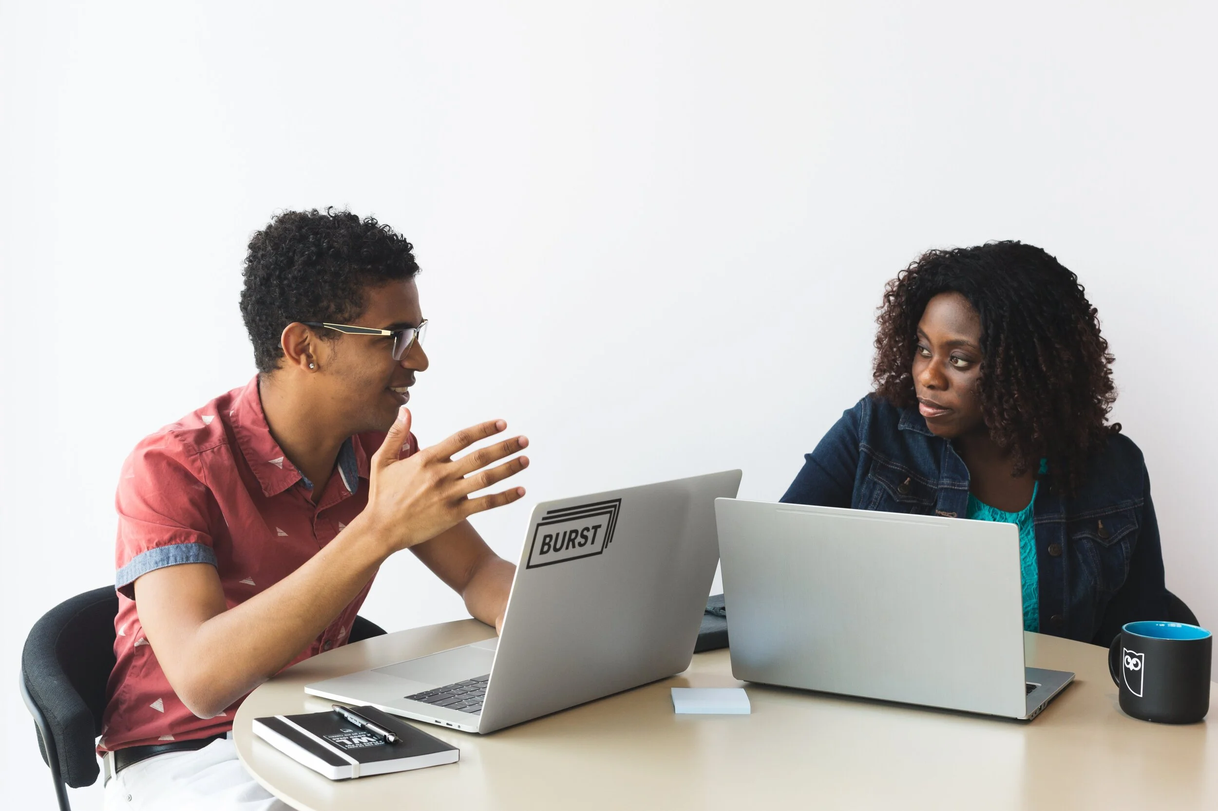 man-and-woman-brainstorming-with-laptops.jpg
