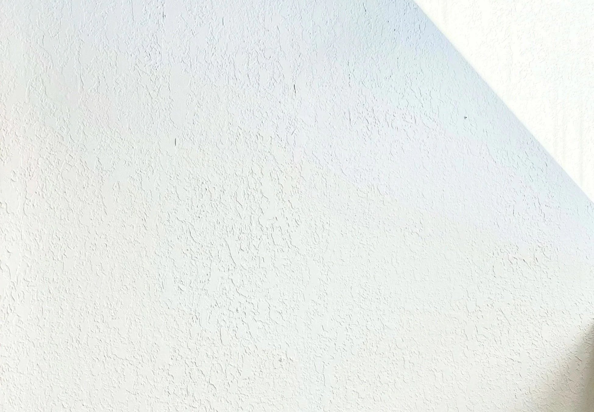 Busy facade on wall with clear light in top right in Andrew Wilton LCSW, stress and burnout therapist's office near Buffalo in Western New York