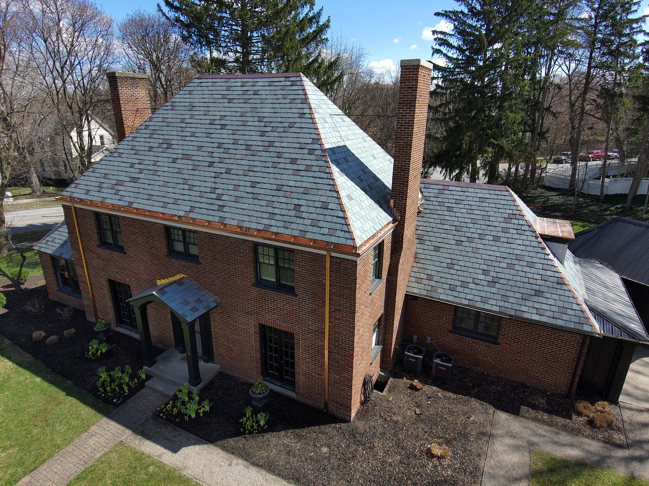 New natural slate roof with custom copper gutters and flashing.