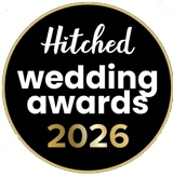 Black circular logo with white and gold text that reads 'Hitched wedding awards 2026'.