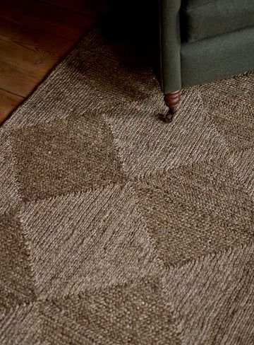 Living room with natural fiber jute rug and solid wood furniture in a Vancouver Island home