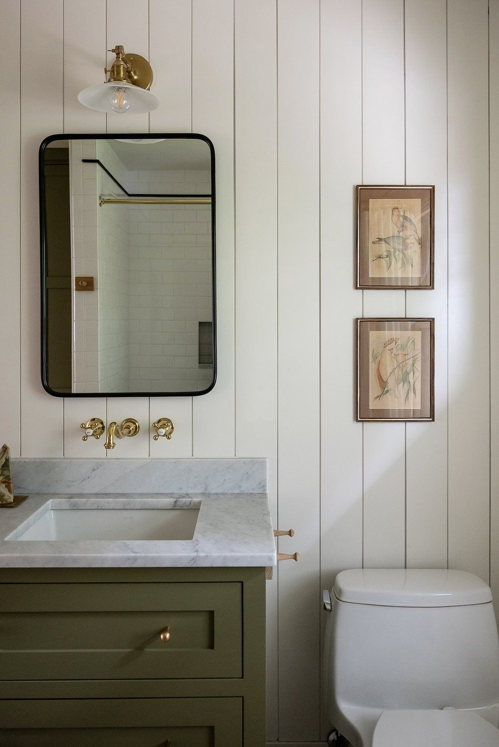 Vancouver powder room with saturated sage millwork and brass hardware