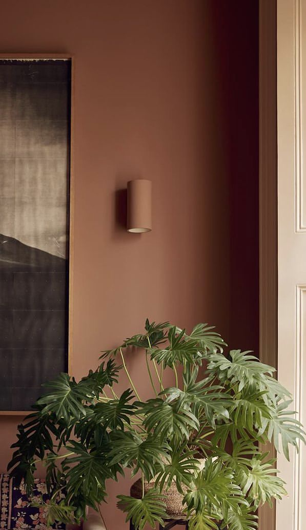 Warm neutral living room with a single bold terracotta accent wall