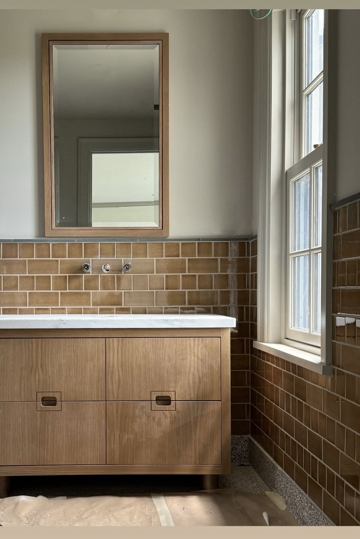 Interior designer reviewing bathroom layout plans for Kitsilano character home renovation