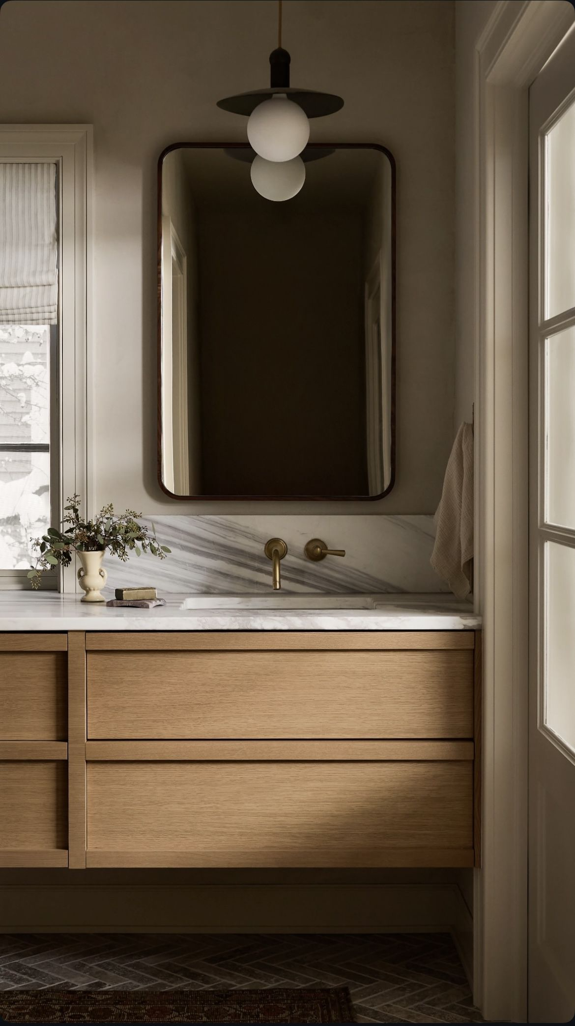 Interior designer reviewing bathroom layout plans for Kitsilano character home renovation