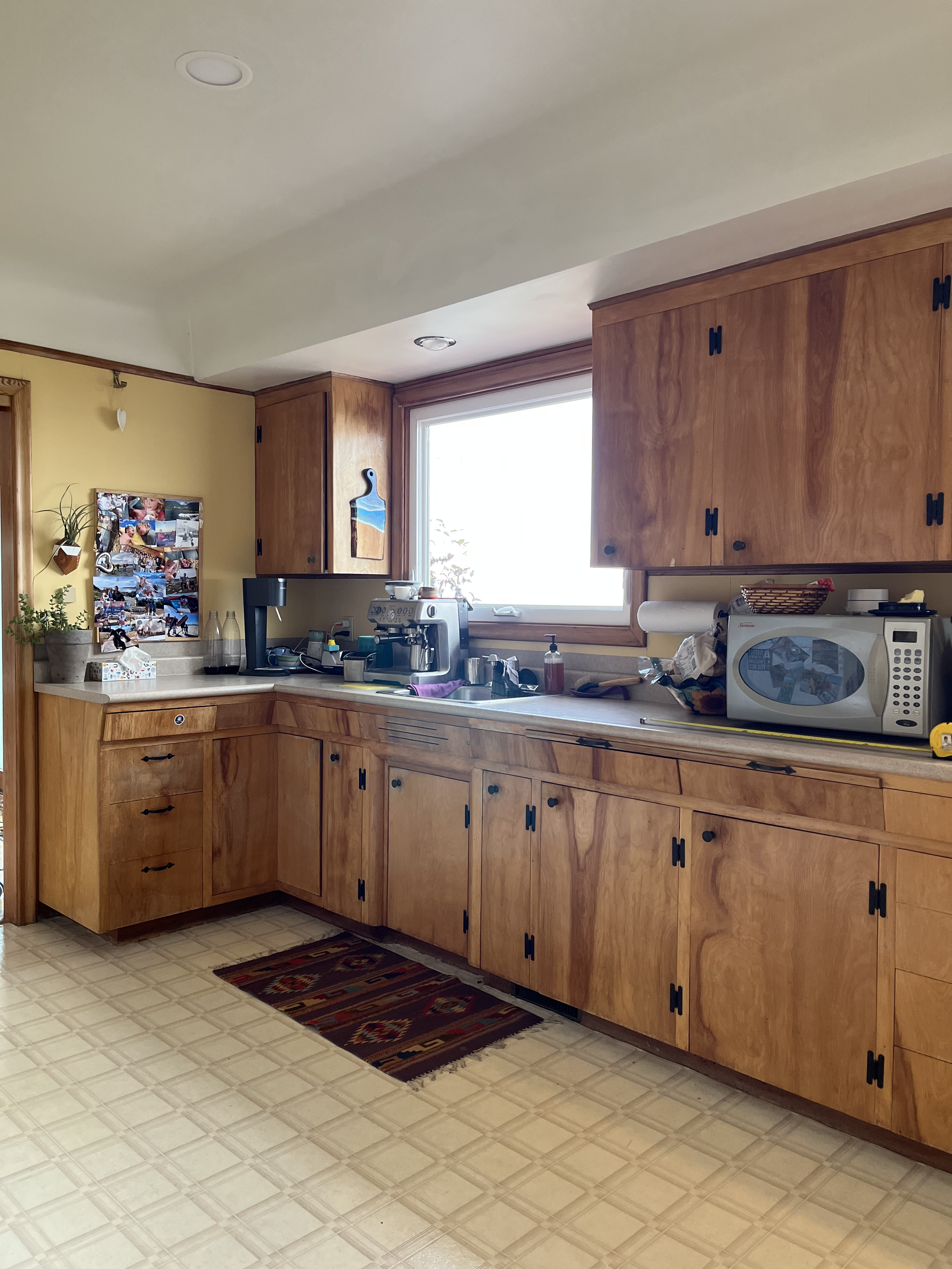 Before the renovation: a Cordova Bay kitchen with an awkward layout and wasted space, overlooking a stunning ocean view that deserved far better.