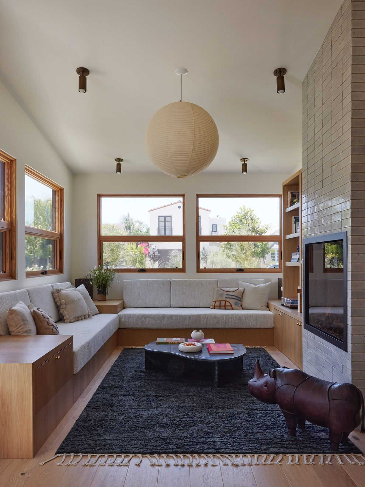 East Van open-plan condo with correctly scaled sectional sofa and continuous flooring
