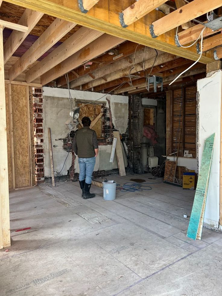Old Vancouver kitchen under renovation with exposed framing and wiring