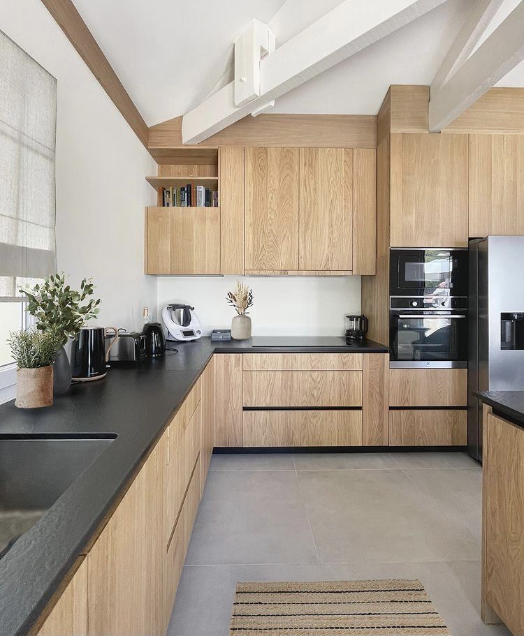 Natural stone slab backsplash continuation in a Vancouver condo kitchen with flat-front cabinets and integrated appliances