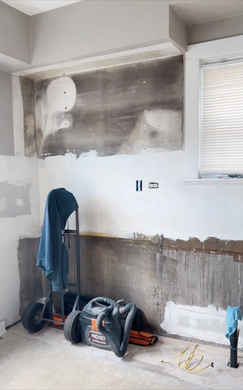 Vancouver kitchen renovation with contractor and designer reviewing floor plans on site