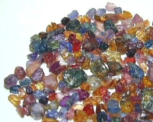 Metamorphic sapphires in rainbow colours - cornflower blues, yellows, purples, pinks.