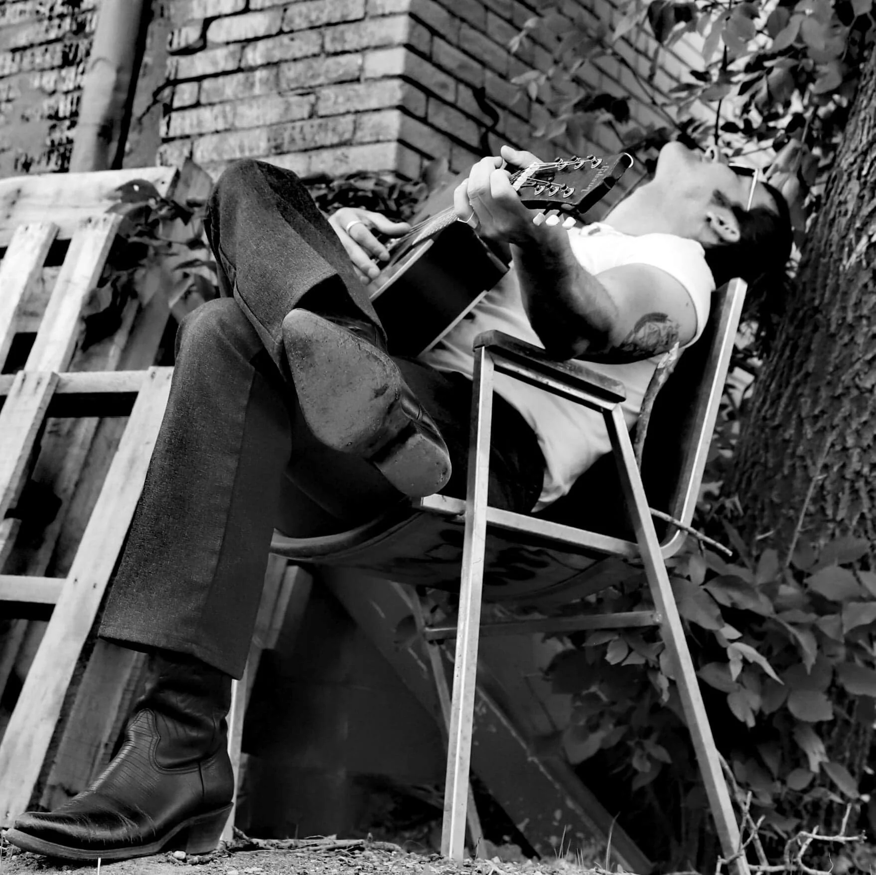 Scott Klein a musican sittiing on a bench in Saskatchewan.