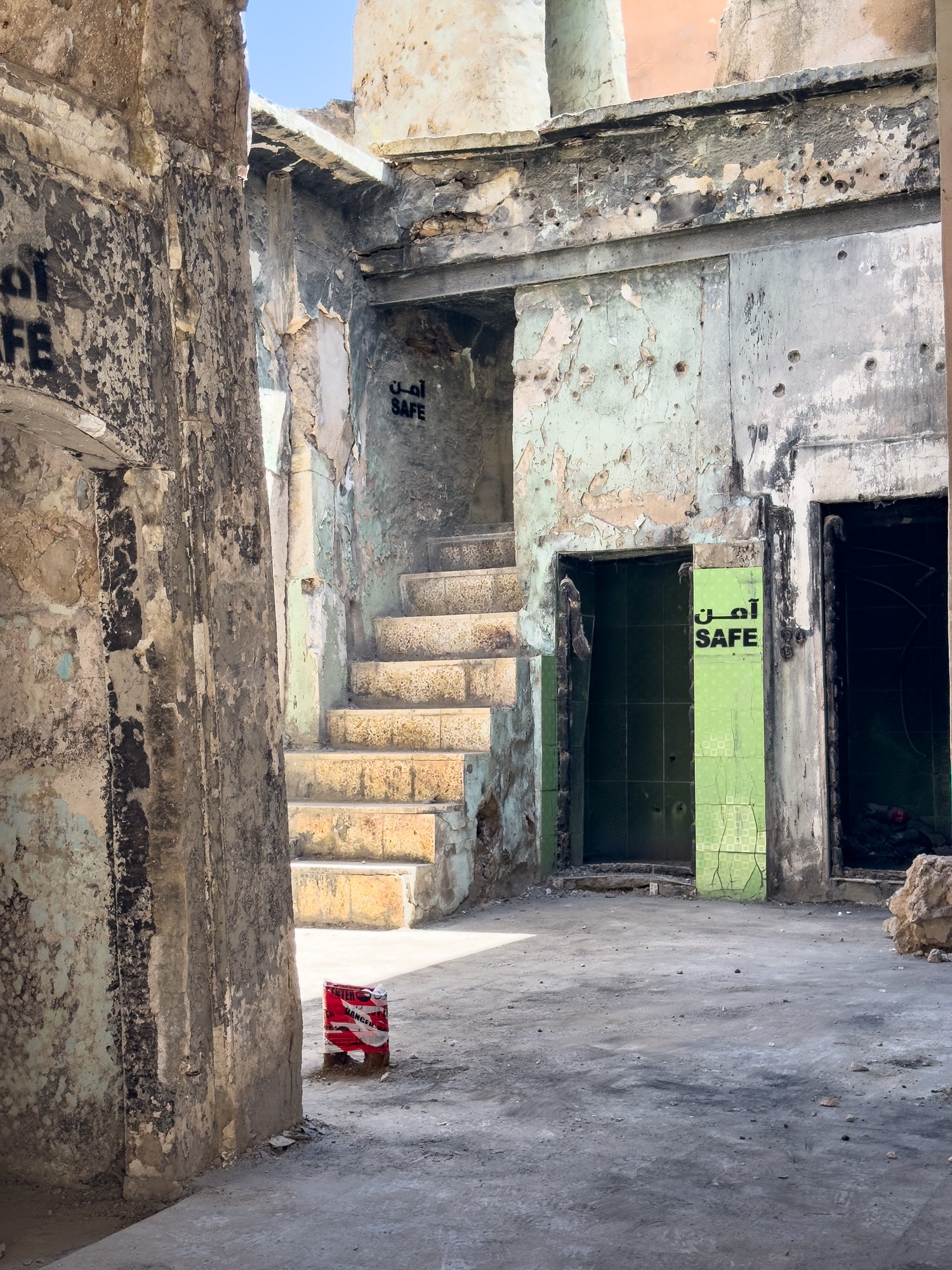 Pockmarked by bullet holes, a former home is declared safe after being cleared of landmines. Many of the ruined buildings are bricked up waiting for restoration at some time in the future perhaps?