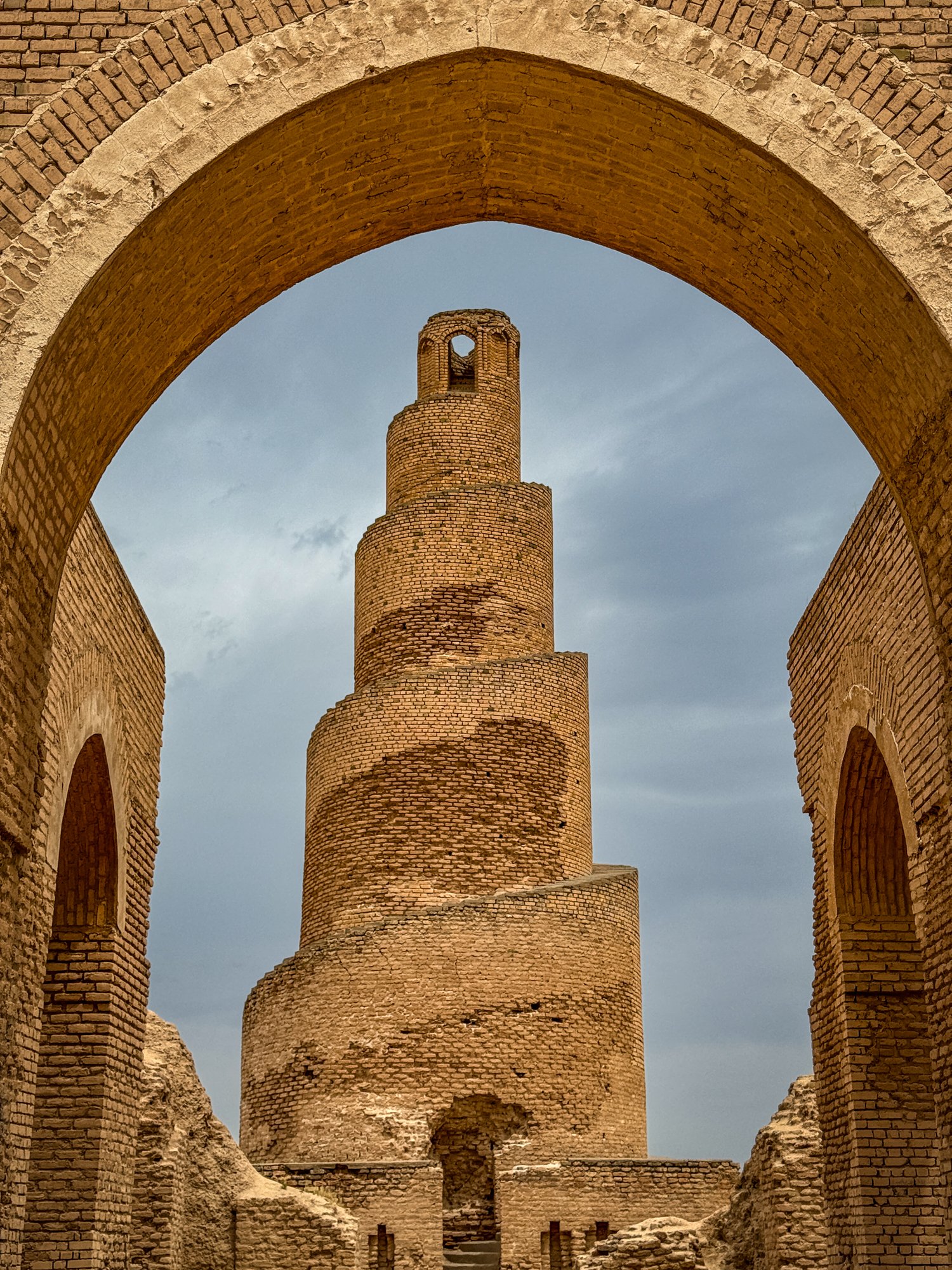 The Great Mosque of Samarra was built by the Abbasid caliph Al-Mutawakkil around 850 CE and largely destroyed by the Mongols. The minaret survived and is built in the shape of a cone, wrapped in a spiraling ramp that leads to the top.