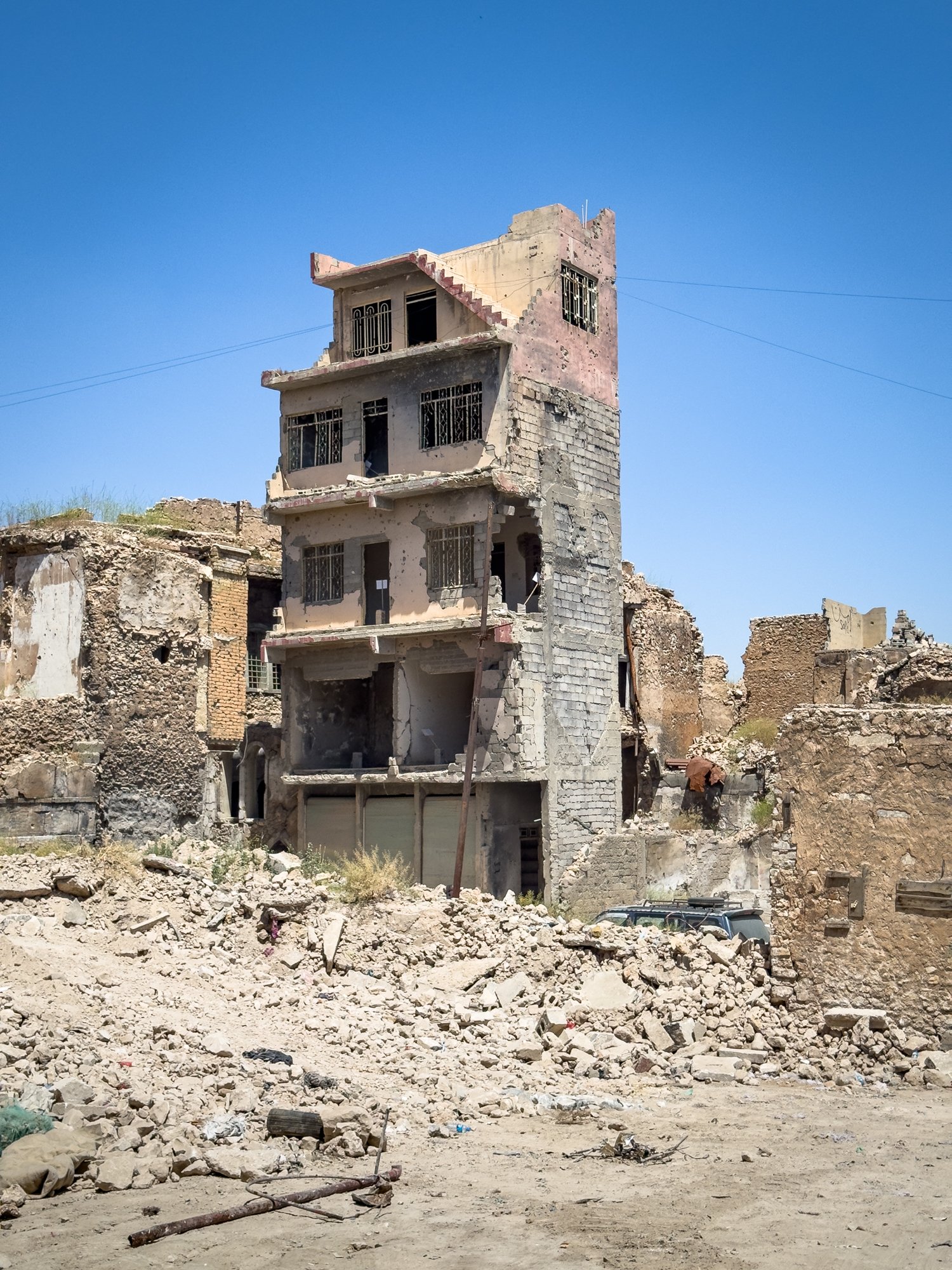 A building remains standing in Old Mosul while all around is reduced to rubble.