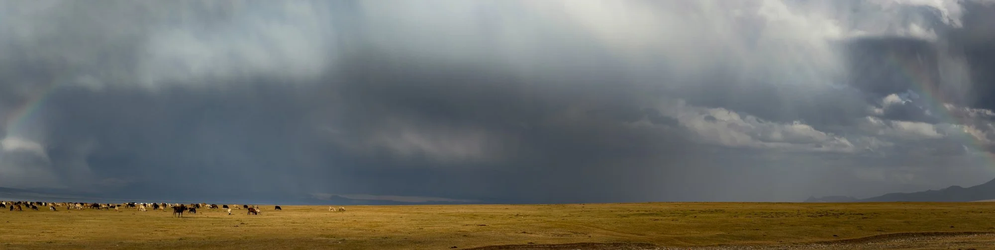 A hail storm and rainbow over Son Kul Lake