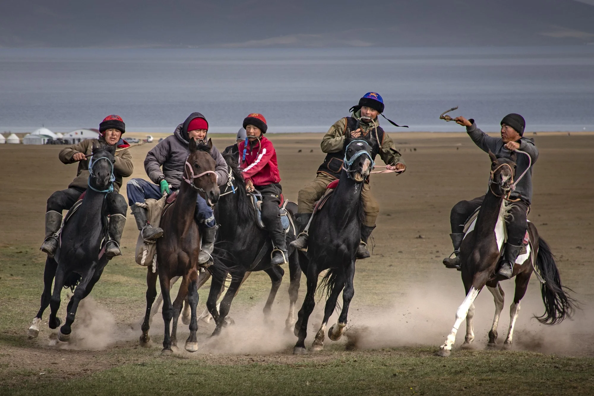The dummy is held by the rider's leg and the race is on to place it in the goal.