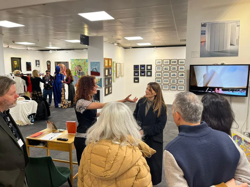 Discussing the work of Julie Groves with a tour group