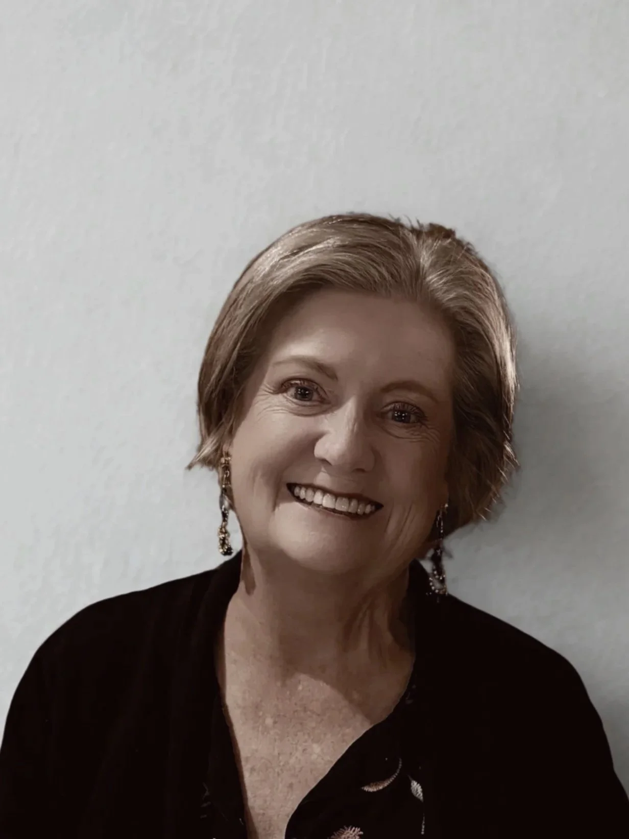 A sober woman smiling at the camera from a sober living home.