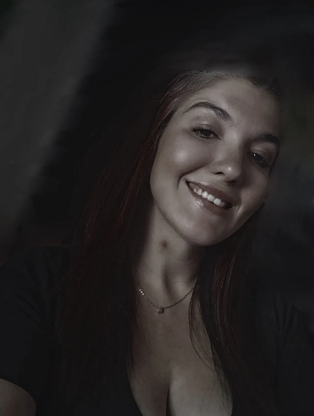 A sober woman smiling at the camera from a sober living home.