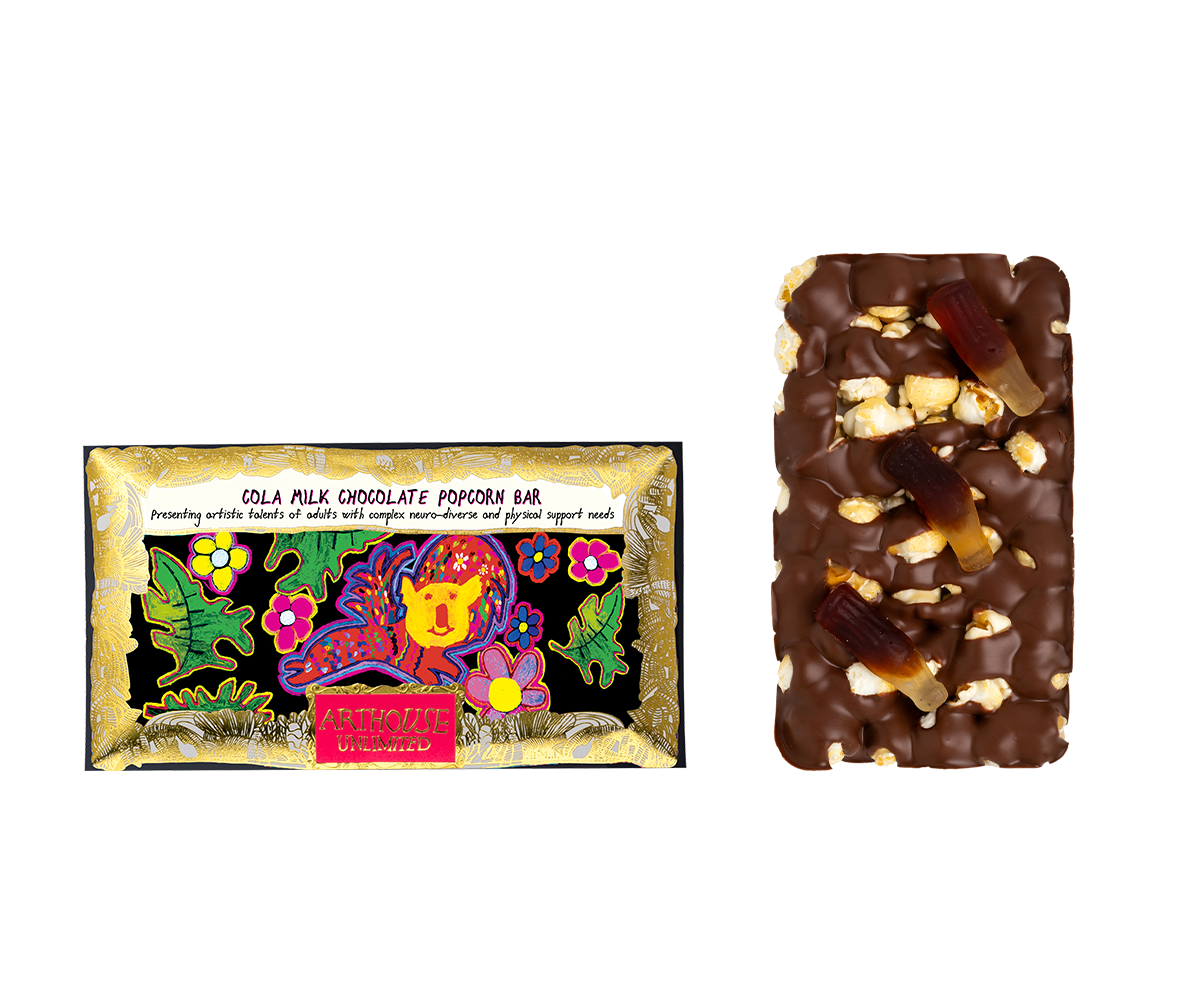 A colorful package of Arthouse Unlimited Cola Milk Chocolate Popcorn Bar next to a chocolate-covered popcorn bar with gummy worms on top.