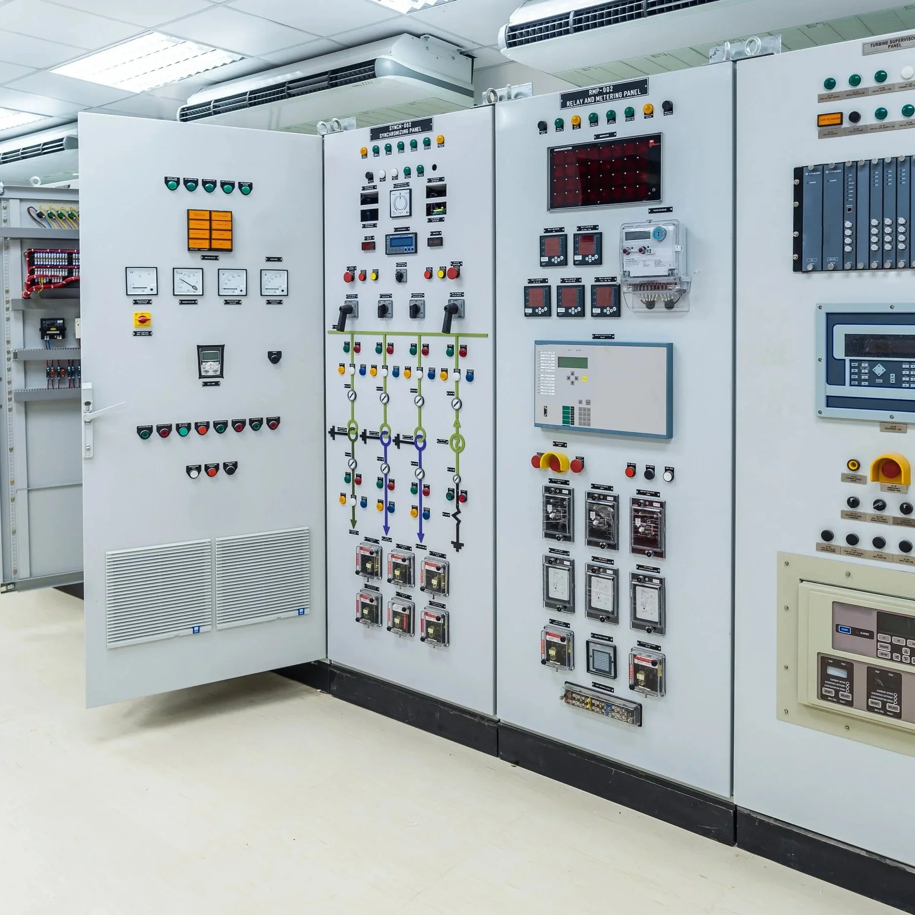 Electrical control panel in an industrial or utility setting with various switches, meters, and indicators.