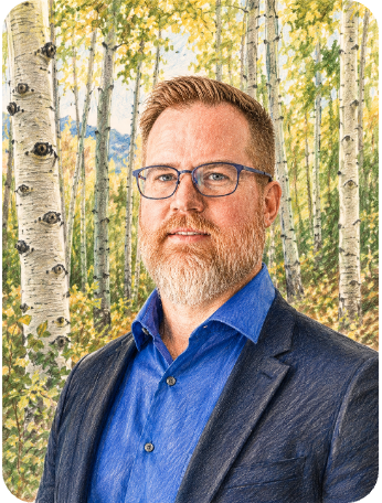 A man with glasses and a beard in a blue shirt and blazer standing outdoors in a forest with white birch trees with yellow leaves.
