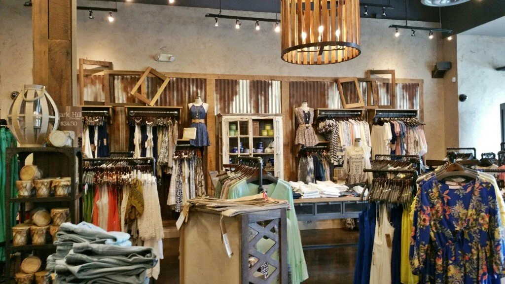 Lizard Thicket Boutique in Knoxville, TN - featuring a custom-built retail display using reclaimed wood and corrugated metal, faux finished to look aged