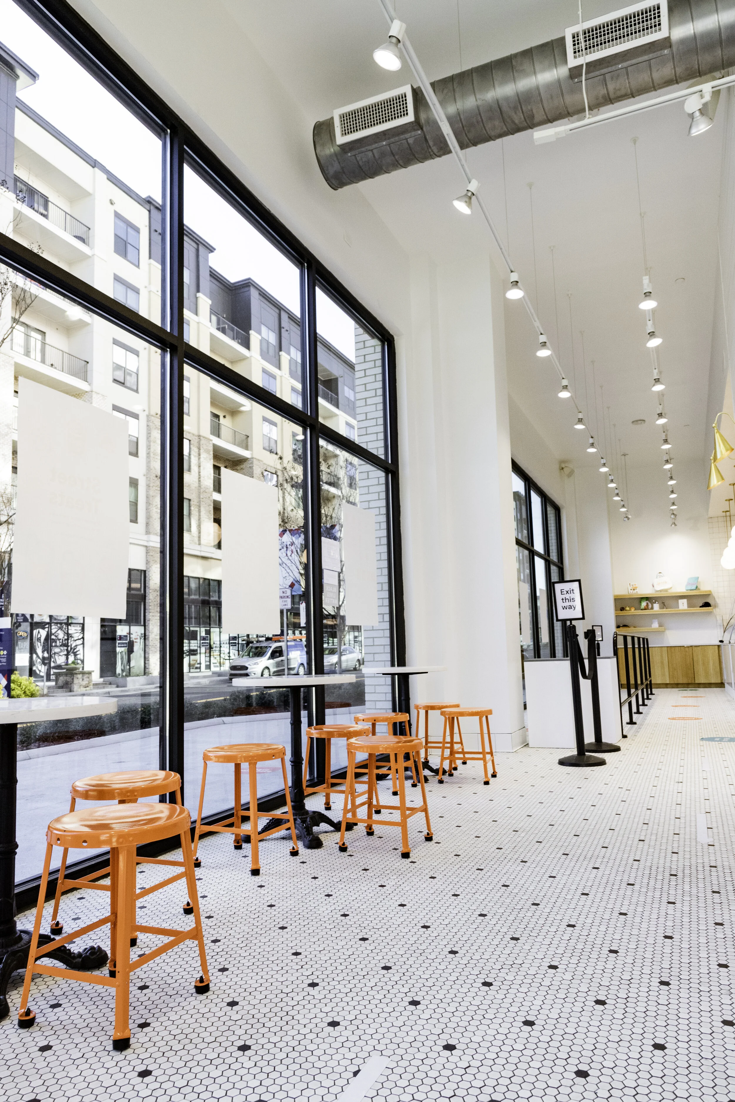 "Commercial general contractor tenant build-out for Jeni’s Ice Cream at The Battery Atlanta, featuring custom tile, high-end millwork, and installed kitchen equipment."

"Licensed commercial contractor interior build-out for restaurant café space at 