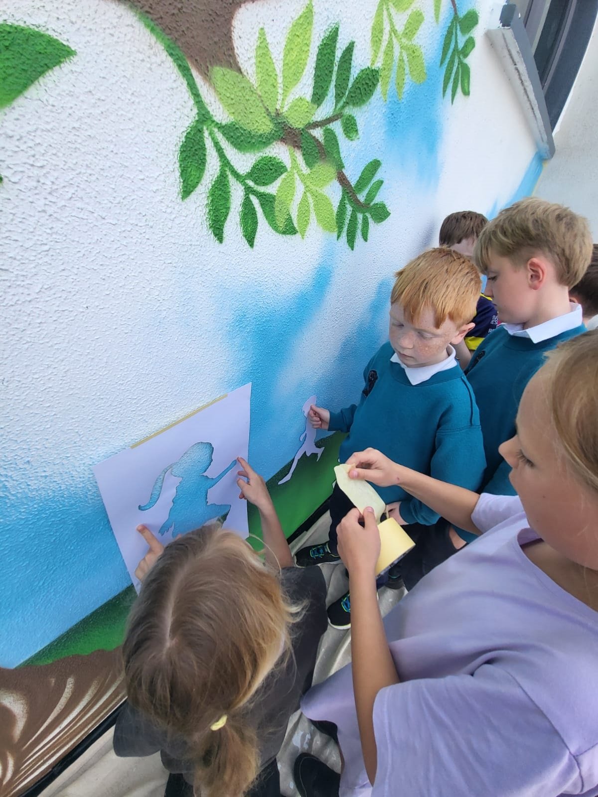 Masking up the children playing stencils.jpg