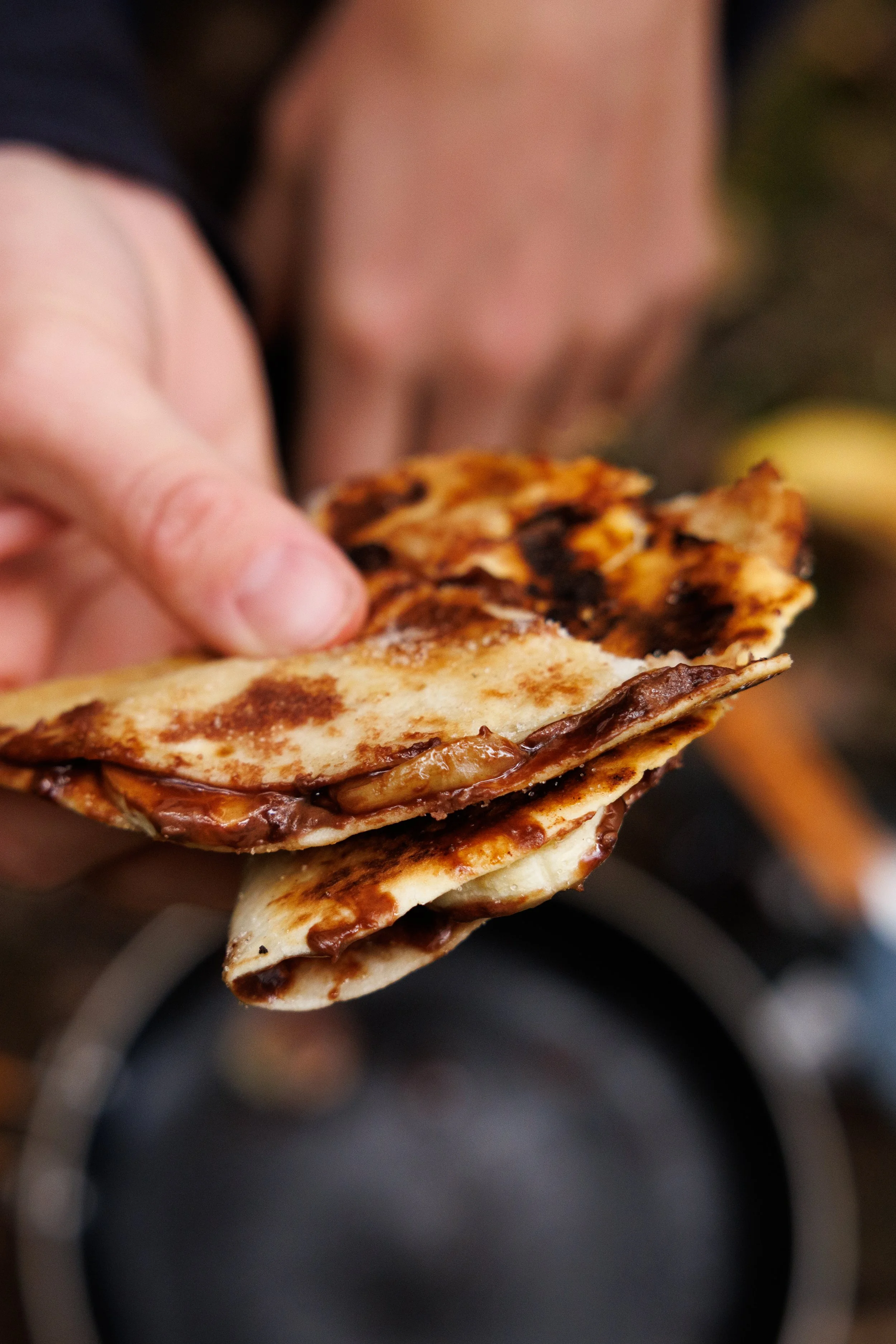hand holding fried nutella and banana wrap