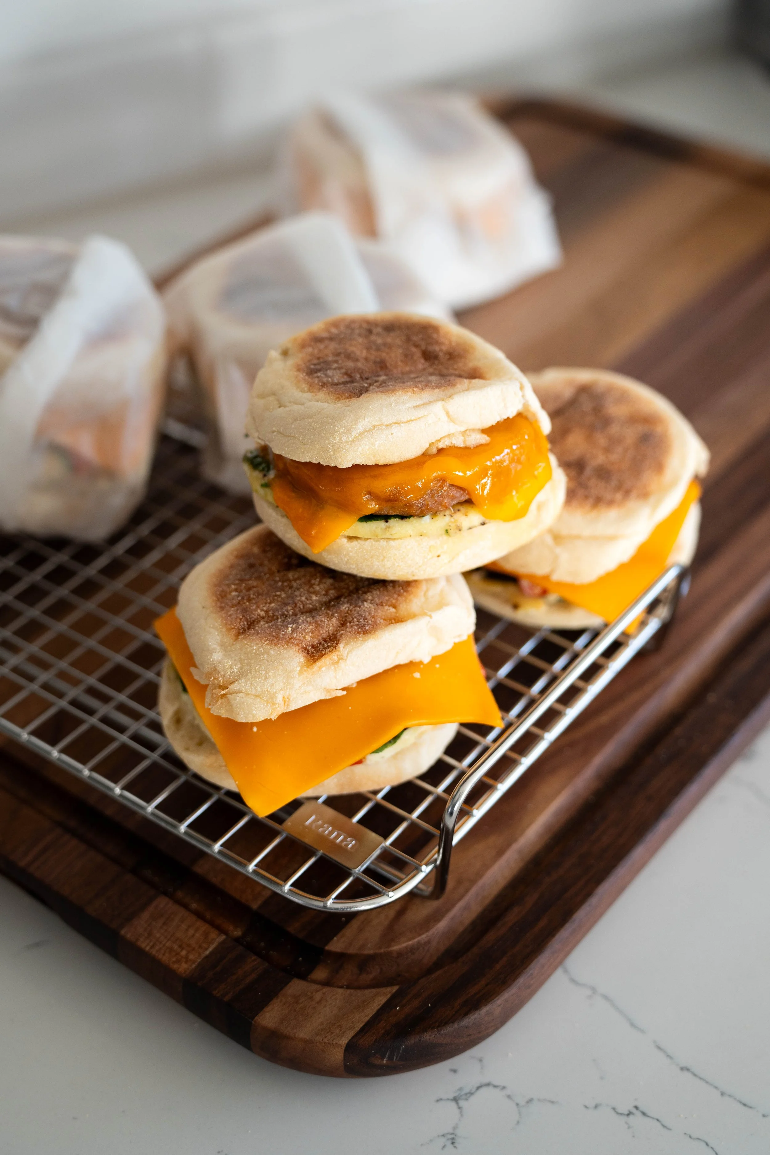 breakfast sandwiches stacked on cutting board